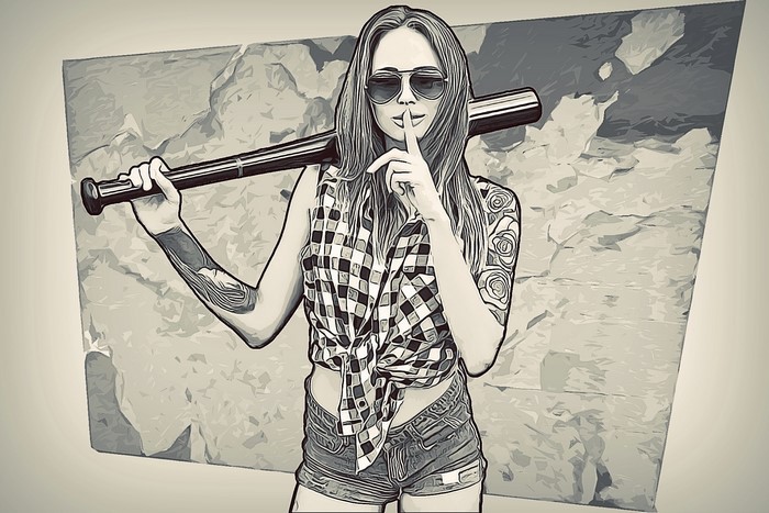 Woman holding a baseball bat with tattoos