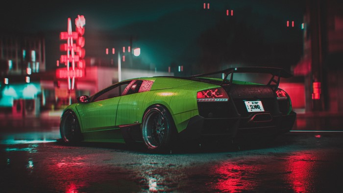 Green Lamborghini Murcielago parked on a wet street at night