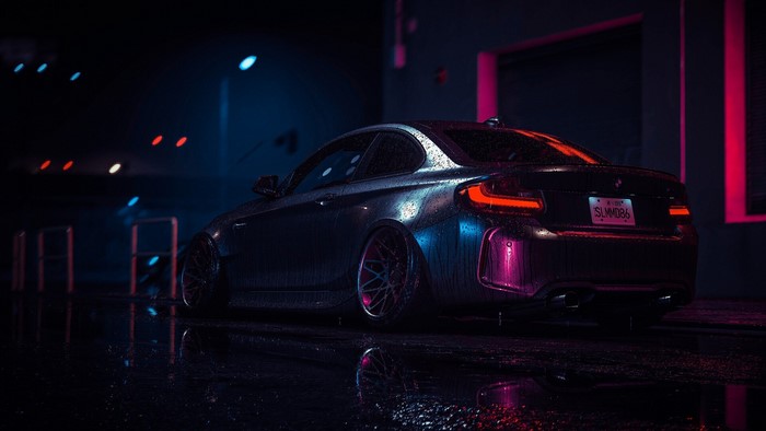 Dark BMW 2 Series car in rain at night