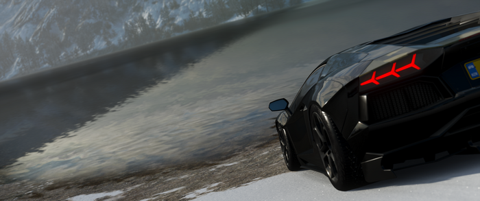 Black Lamborghini Aventador J on a snowy shore