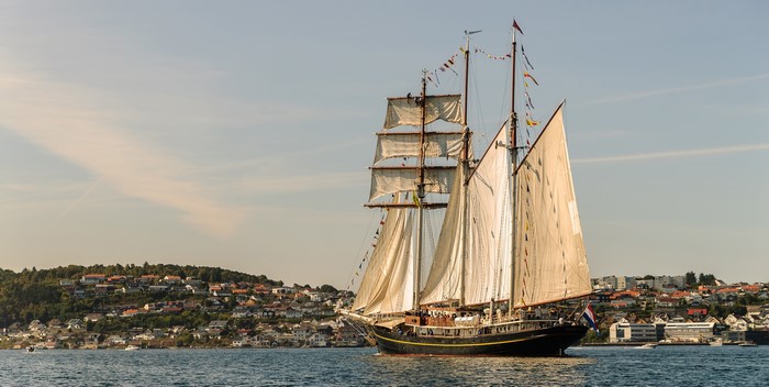 Sailing ship with full sails on the water