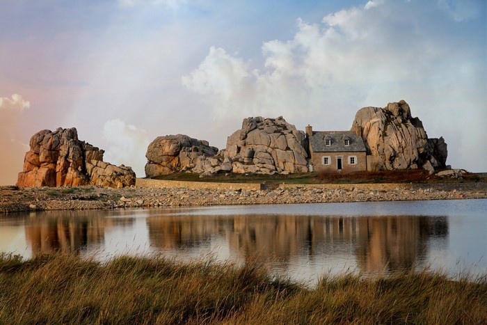 House built among rocks by the water in Plougrescant, France