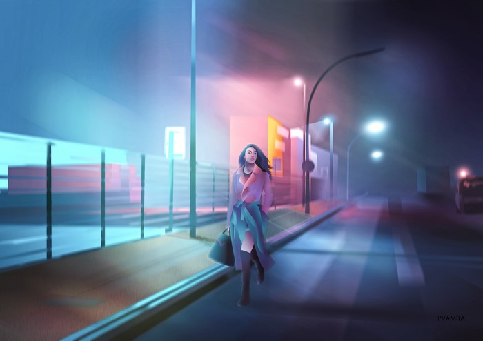 Woman walking in a city at night