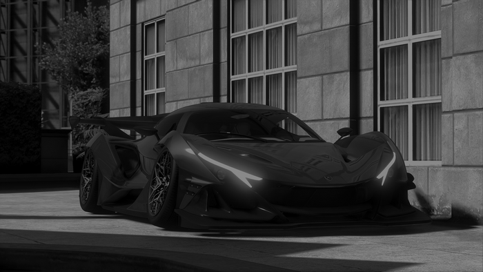Black sports car parked in front of a building