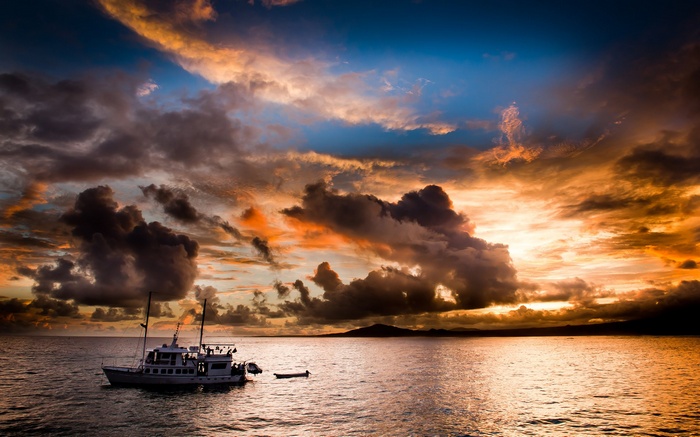 Boat on the ocean during a dramatic sunset