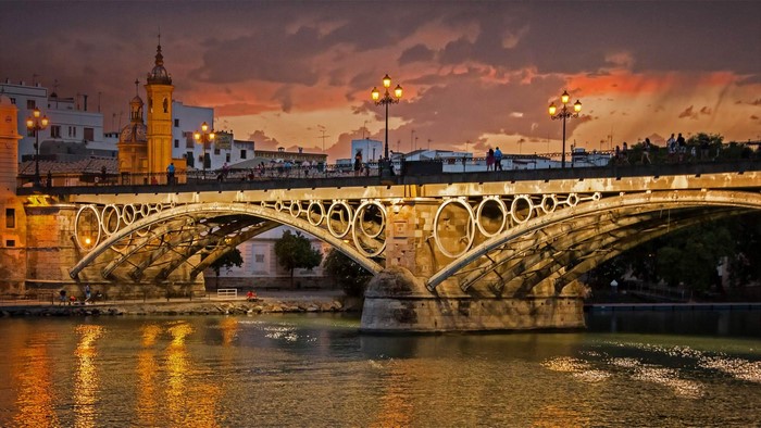 Puente de Isabel II bridge over Guadalquivir River at sunset