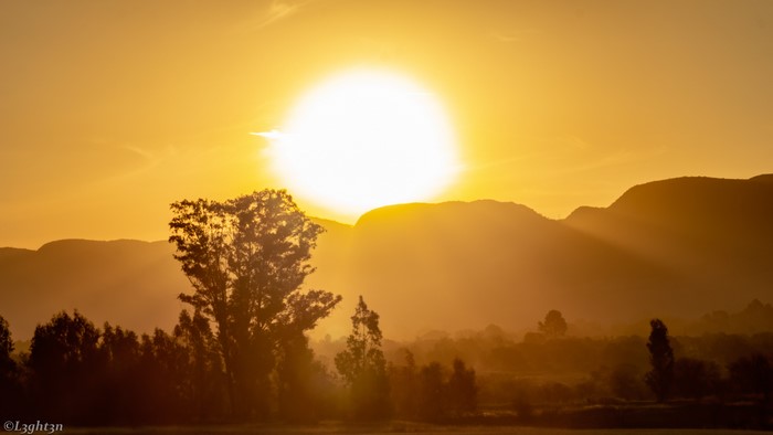 Sunset over mountains with trees