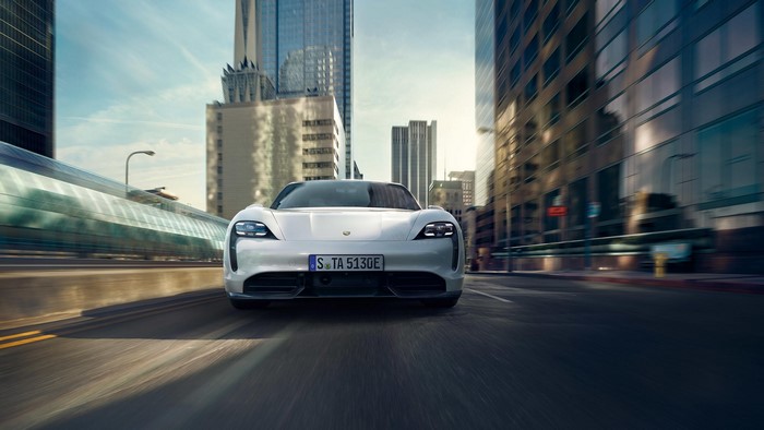 Porsche Taycan electric car driving on a city street