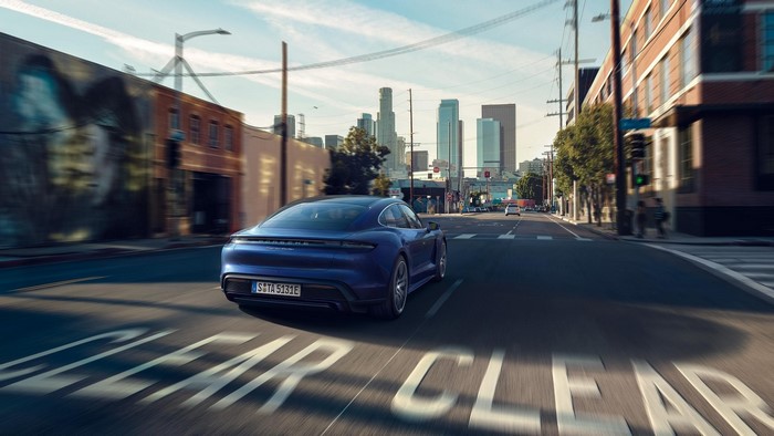 Blue Porsche Taycan driving on a street in Los Angeles