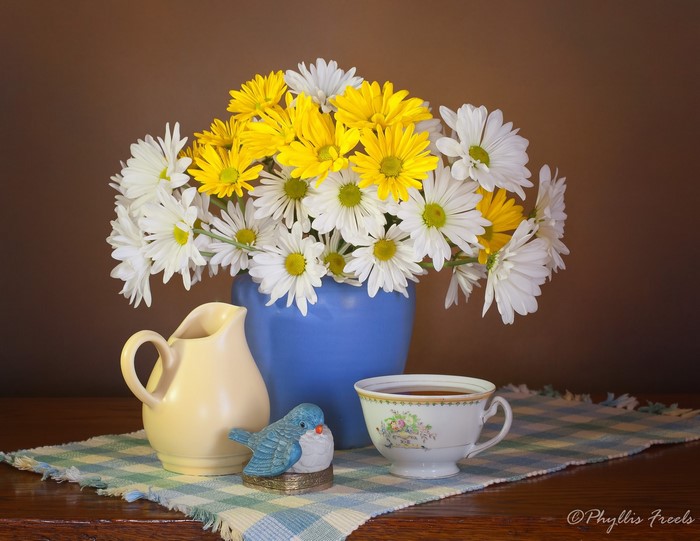 Still life with daisies, pitcher, and teacup