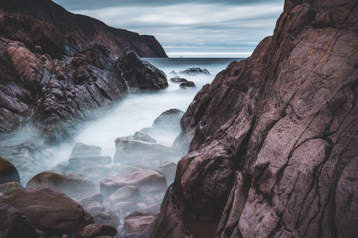 Long exposure of rocky coast with misty ocean