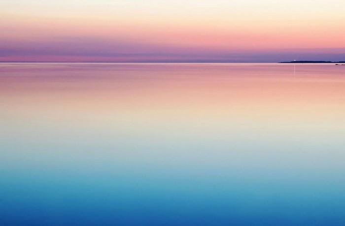 Sunset over the ocean with purple sky