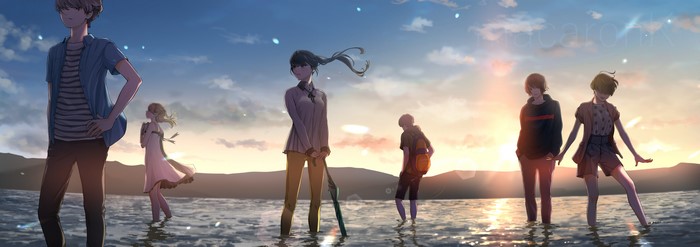 Group of people standing in water at sunset