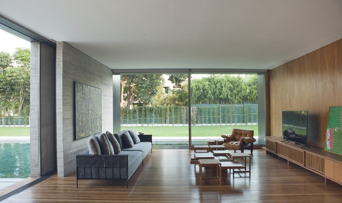 Modern living room with large windows and wooden walls