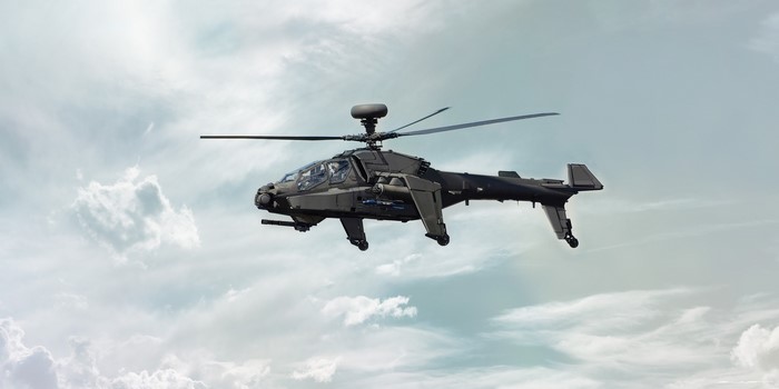 Dark military attack helicopter in flight