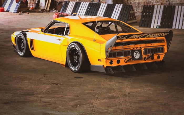 Orange Ford Shelby GT500 with large rear spoiler