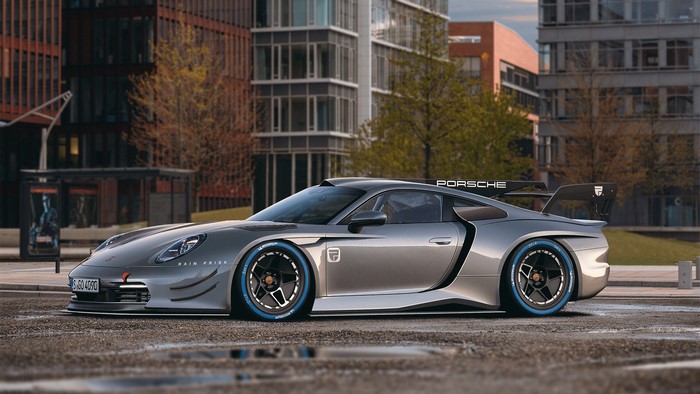 Silver Porsche 992 GT1 race car with blue tire accents