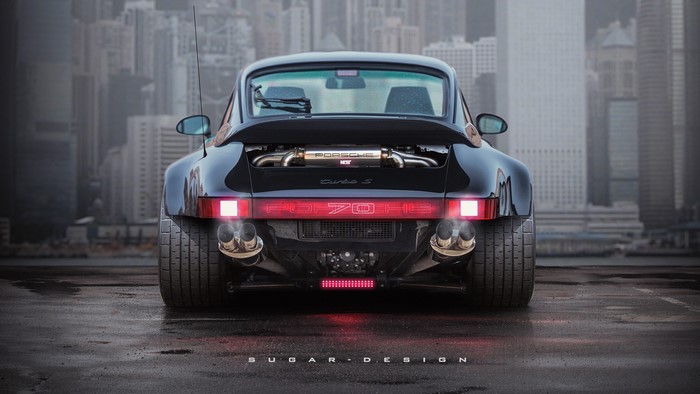 Black Porsche Turbo S rear view with city background