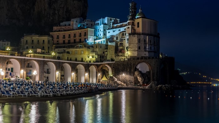 Amalfi Coast town at night with beach and sea