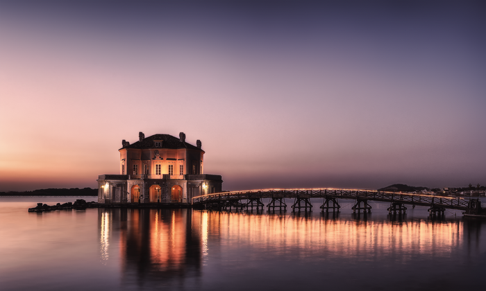 Casina Vanvitelliana and bridge over lake Fusaro at sunset