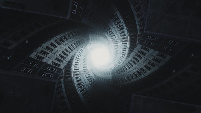 Twisting apartment buildings leading to a bright light