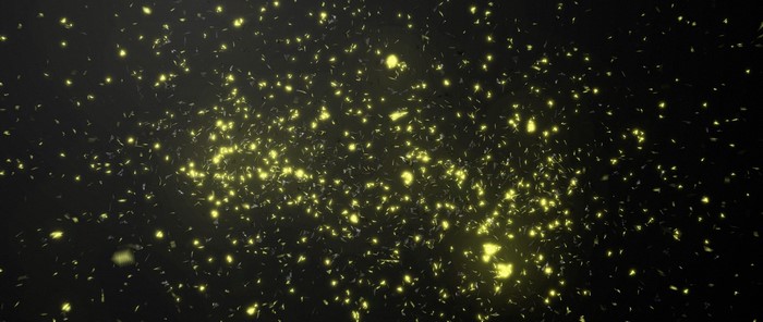 Glowing yellow particles in dark space