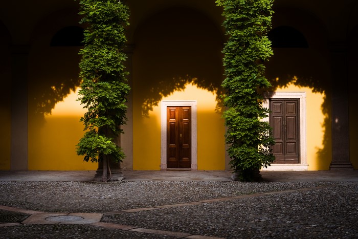 Courtyard with yellow wall and two doors