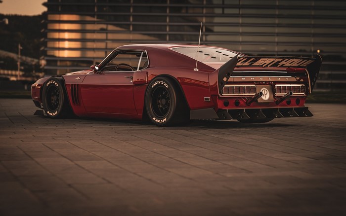 Custom red Shelby Mustang with a large rear spoiler
