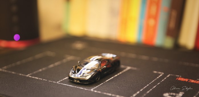 Black Ferrari 458 GT2 toy car with racing stripes