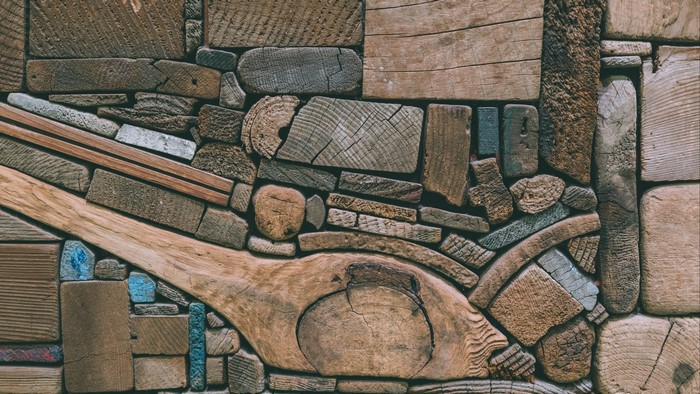 Abstract mosaic of various wood pieces and some blue accents