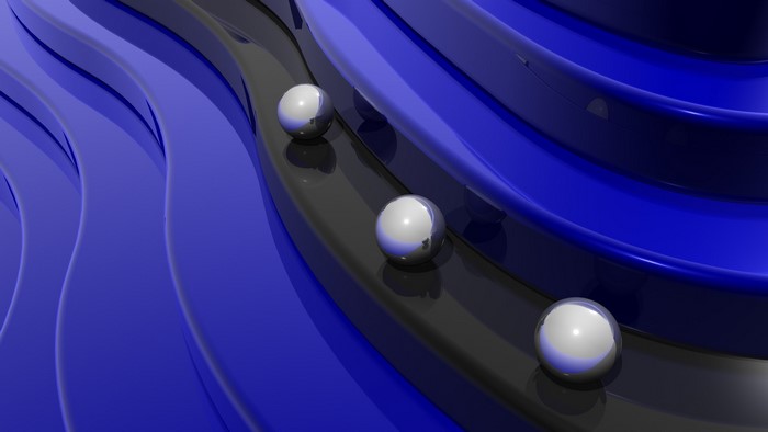 Abstract 3D render of chrome spheres on blue and black wavy tracks