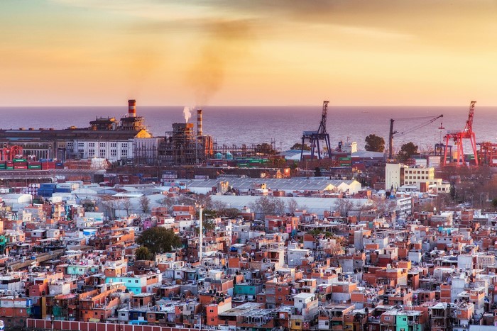 Cityscape with industrial port and residential area at sunset