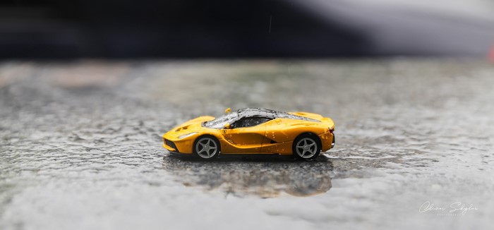 Yellow Ferrari LaFerrari toy car in rain