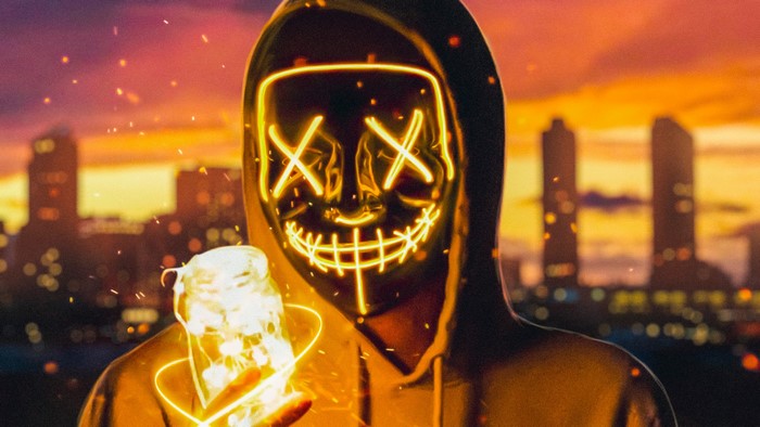 Neon Fire Masked Figure at Sunset