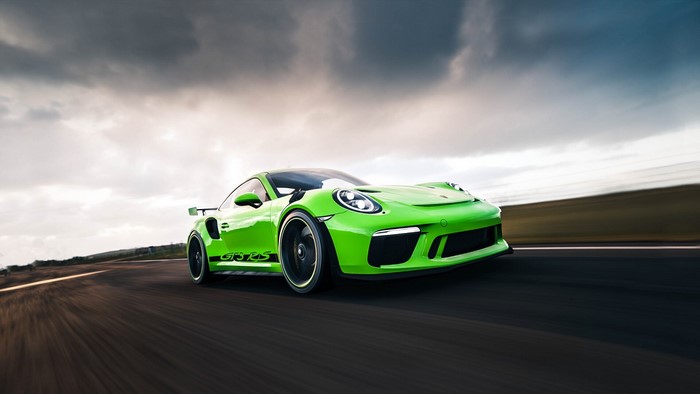 Green Porsche 911 GT3 RS driving on a road