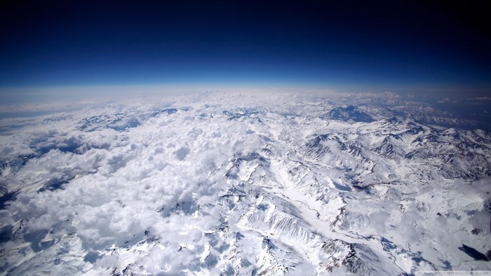 Aerial view of snow-covered mountains and clouds