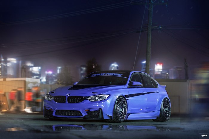 Purple BMW M3 with Toyo Tires banner at night