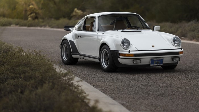 White Porsche 930 Turbo sports car on a road