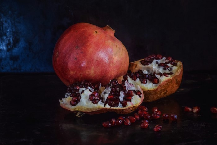 Still life of a pomegranate and its seeds