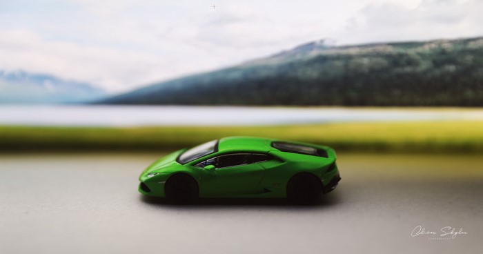 Green Lamborghini Huracan toy car with scenic background