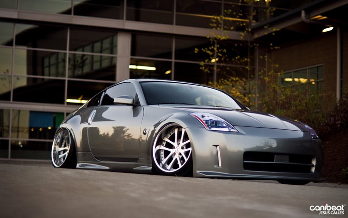 Silver Nissan 350Z parked in front of a modern building