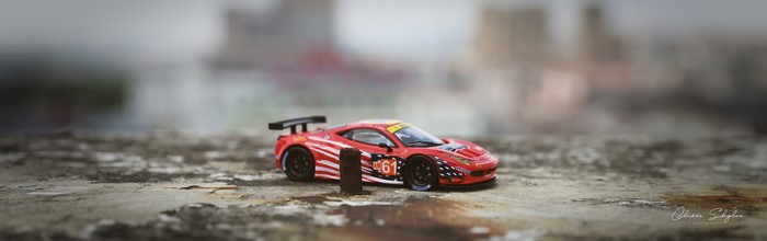 Red Ferrari 458 race car with number 61