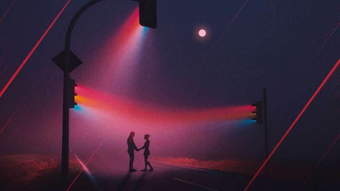 Couple holding hands under traffic lights at night