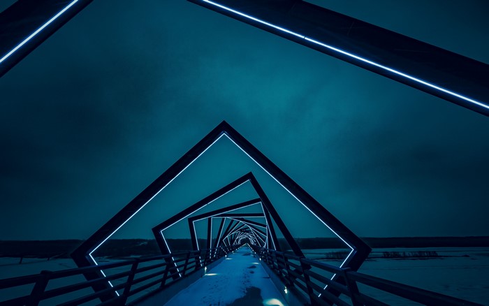 Geometric bridge with blue lights at night