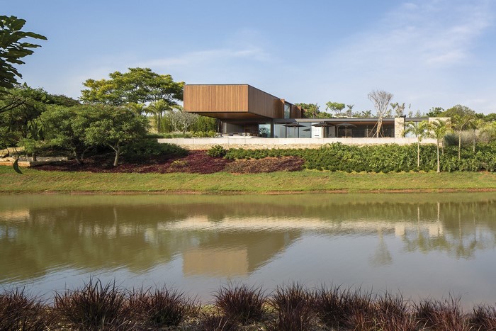 Modern house with cantilevered section overlooking a lake