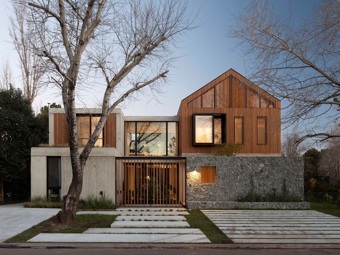 Modern concrete and wood house with stone wall