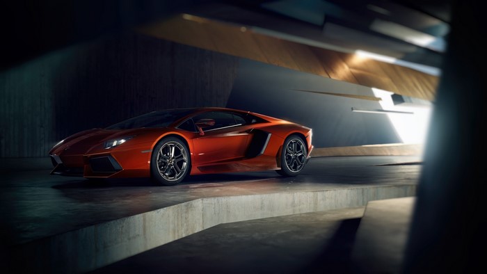 Orange Lamborghini Aventador in a modern garage