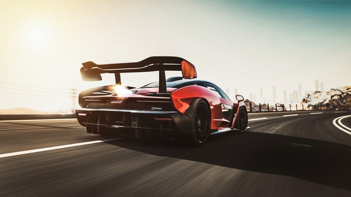 Red McLaren Senna driving on a road