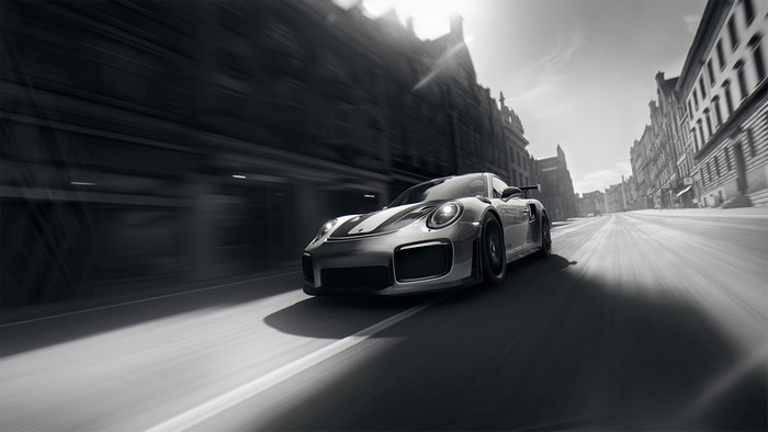 Monochrome Porsche 911 GT2 RS racing through city