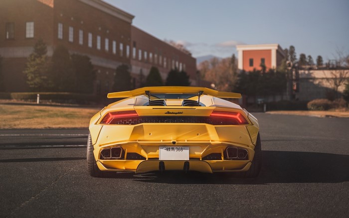 Yellow Lamborghini Aventador LP700 with a large rear wing